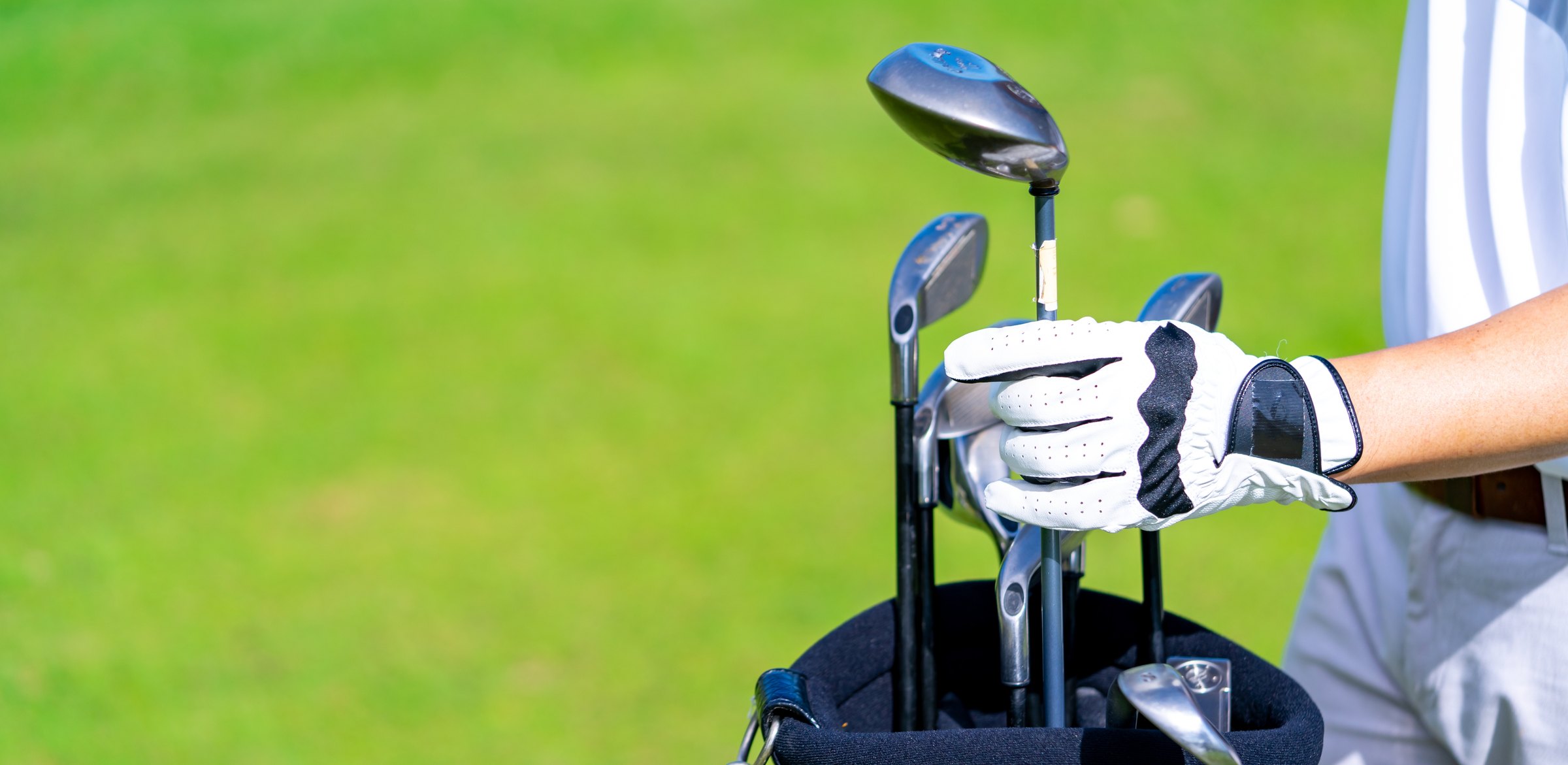 Golfer taking a club out of the bag
